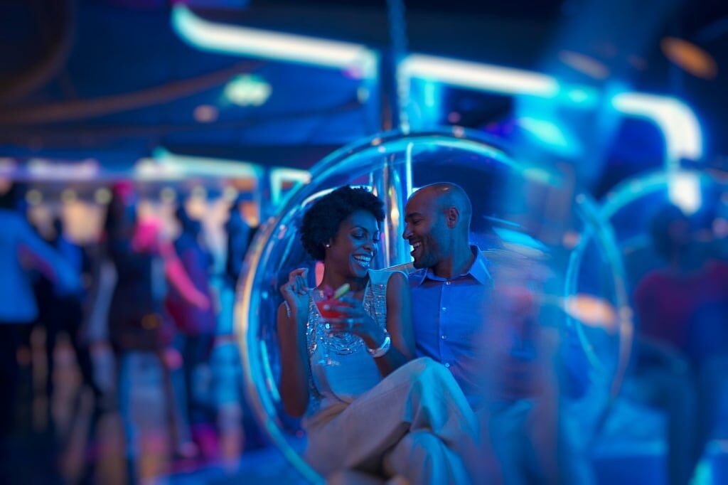 Couple on a couch under dim lights in Quasar